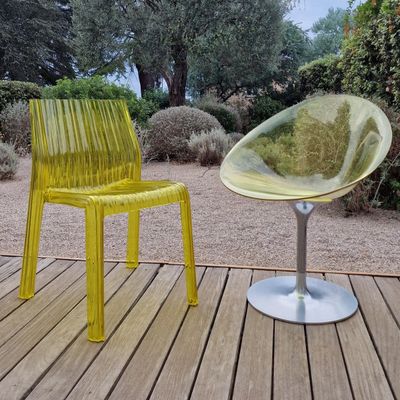 a yellow chair and a yellow chair sitting on a wooden deck