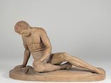 an image of a statue of a man laying on the ground