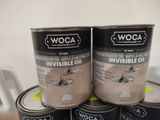 three tins of wood flooring paint sitting on top of each other