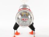 a toy robot that is sitting on some orange feet