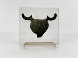 a glass box with a metal object inside of it