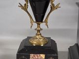 a black and gold vase and a black and gold clock
