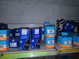 several boxes are stacked up on a shelf in a store