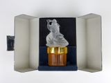 a cupcake in a box with a frosting bear on top