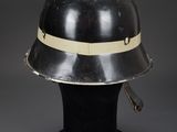 a silver helmet with a white band on top of it