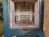 a blue oven that has a bunch of pots on top of it