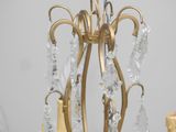 a gold chandelier with crystal beads hanging from it