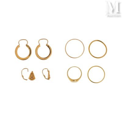a close up of a group of gold earrings on a white background