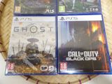 three playstation game cases sitting on top of a wicker basket on a table