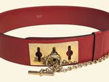 a red belt with a gold buckle and a chain