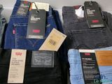 several pairs of men ' s jeans are on display in a store