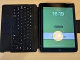 a tablet and a laptop on a desk next to each other