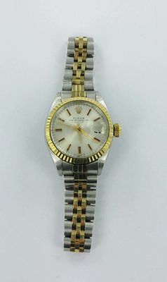 a close up of a watch on a white surface with a white background