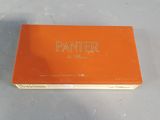 an orange box of paint sitting on top of a white table