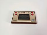 an old game console sitting on top of a white table