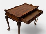 an old wooden table with a drawer on top of it