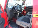 a red truck with the driver ' s seat up