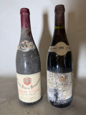 two bottles of wine sitting next to each other on a table