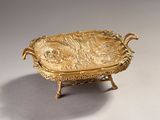 an image of a gold plate with a fish on it