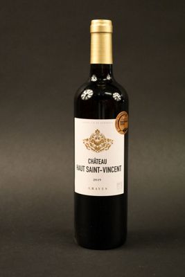 a close up of a bottle of wine on a black background