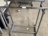 an image of a metal table with a shelf on top of it