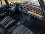 dashboard of a classic car with black leather seats and dashboard controls