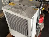 an air conditioner sitting on top of a pallet in a garage