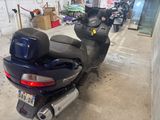 a scooter parked in a garage with other scooters