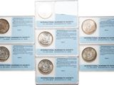 six different types of silver coins are in a display case