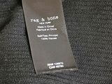 a close up of a label on the back of a black shirt