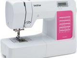 the sewing machine is white and has pink trims on it