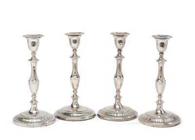 SUITE DE QUATRE FLAMBEAUX en argent lesté, à décor de cannel…