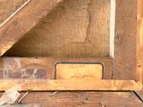 a wooden frame with a sign on it in the corner of a room