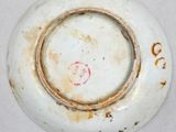 a close up of a white plate with rust on it