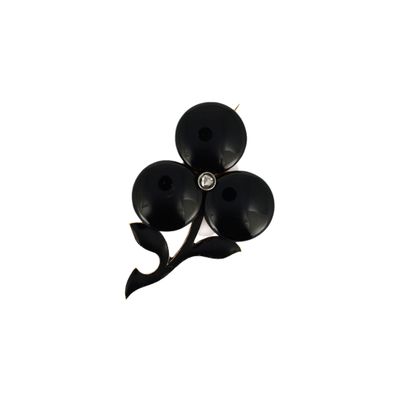 a picture of a black flower brooch with a diamond center