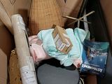 a cardboard box filled with assorted items including a mannequin