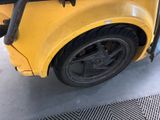 a close up of a yellow school bus parked in a garage