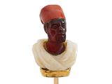 une image représentant une figurine d'homme fixée sur un bâton