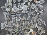 a pile of clear glass pieces sitting on top of a black surface