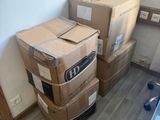 many boxes stacked on top of each other in a room