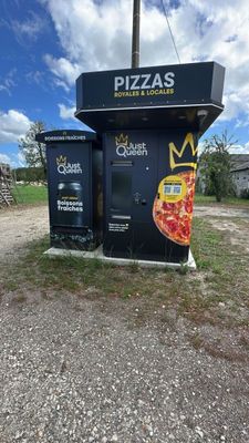 a black box with a pizza on it sitting in the middle of the road
