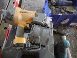 a picture of a cordless nailer and other tools on a table
