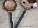 three metal spoons sitting on a table next to a bowl