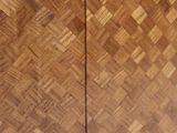 a close up of a wooden cabinet with a sliding door