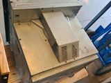 a microwave sitting on top of a pallet in a garage