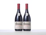 two bottles of red wine sitting on top of a table