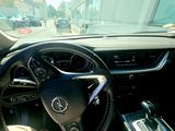 a steering wheel and dashboard of a car on a city street