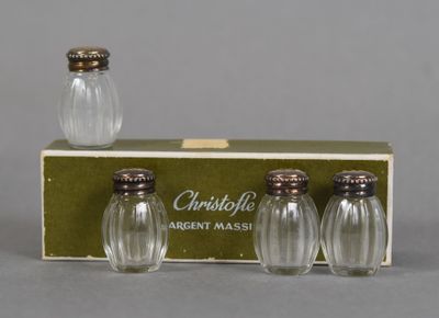 three glass salt and pepper shakers in a box on a table