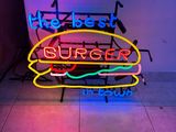 a neon sign that says the best burger in the world
