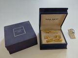 a box that has a pair of gold cufflinks in it